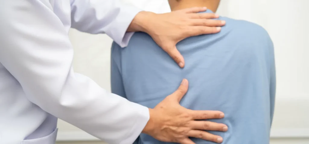 doctor helping with back pain