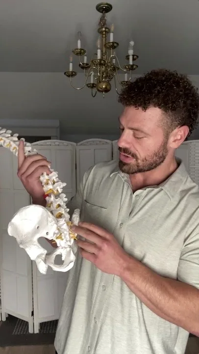 Dr. Shane Wend explaining spinal anatomy using a model